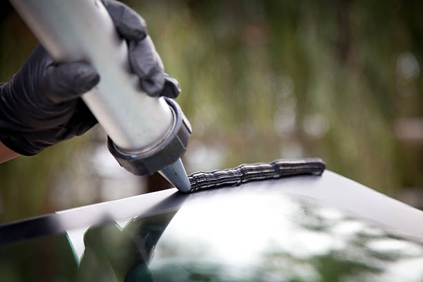ZenGlassAuto offers you Premium Quality Professional auto glass technician inspecting a newly installed windshield